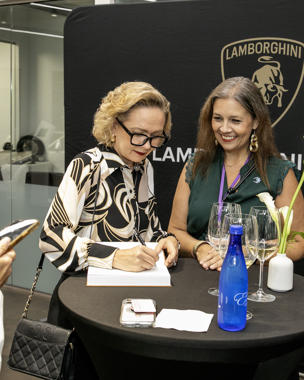 Tarja signing a copy of the book for a reader at Lamborghini Miami.