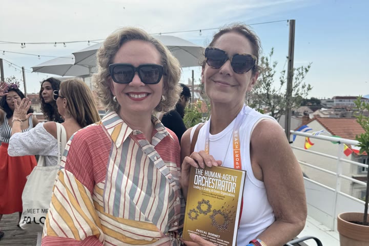 Two readers with the book on a Miami terrace.